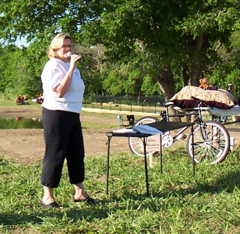 Susan as auctioneer.